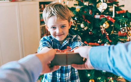 menino recebendo presente de natal