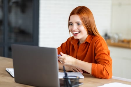 Mulher Sorrindo olhando para o notebook