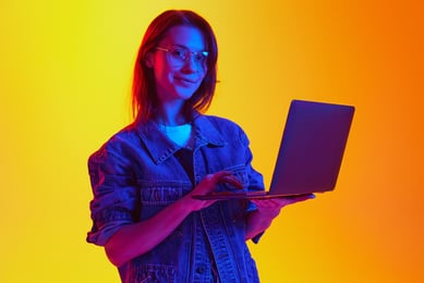 mulher jovem com óculos com notebook na mão 